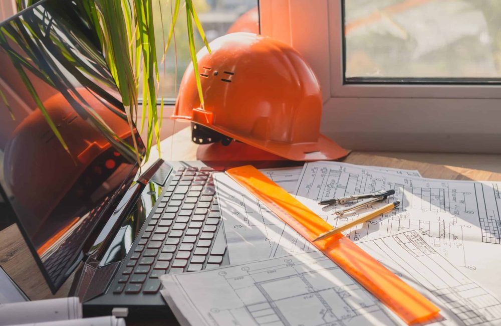 architect design working drawing sketch plans blueprints and making architectural construction model in home.